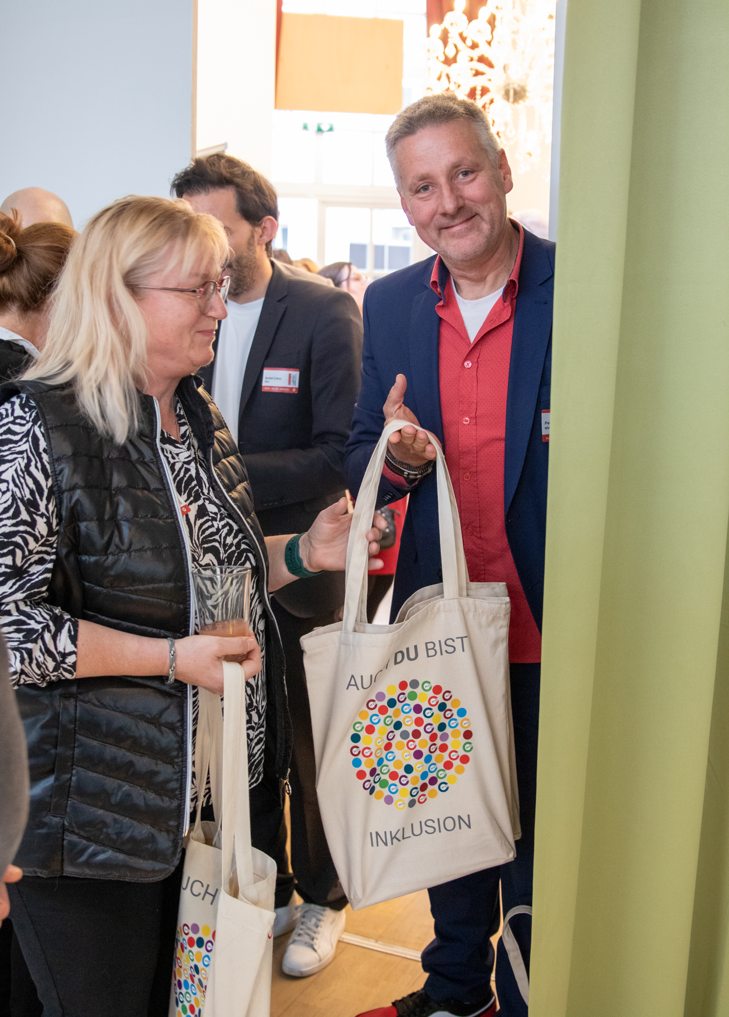 Außendienstmitarbeiter hält MVG Jutebeutel mit der Aufschrift "auch ich bin Inklusion"